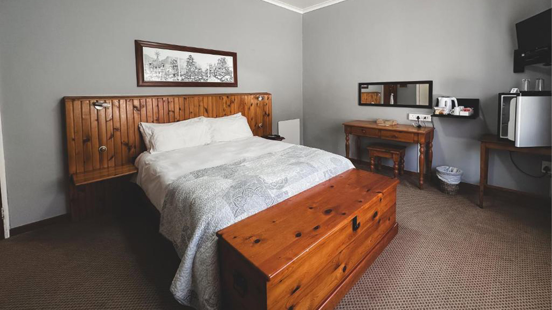A made-up double bed in a chalet room